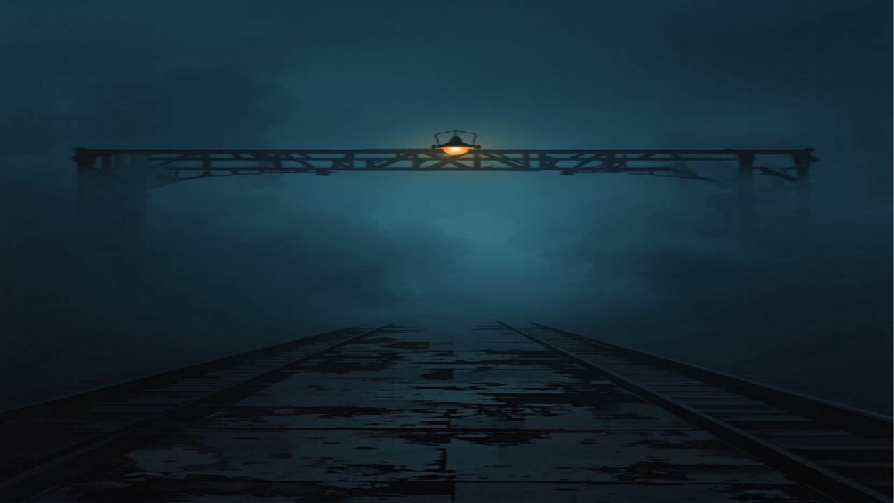 霧の中へ消えていく夜の線路